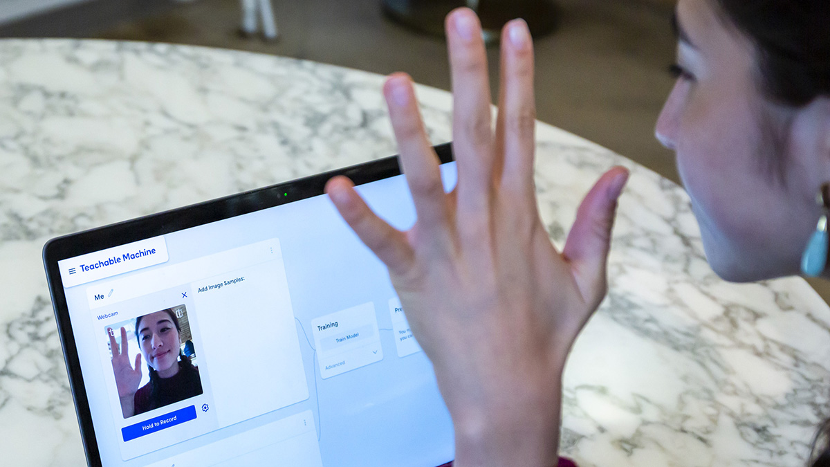 Person waving in front of teachable machine website